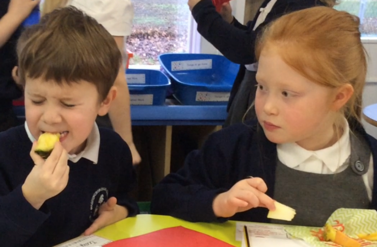 School children tasting veg