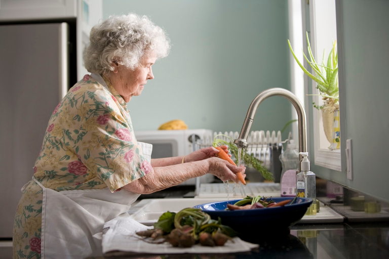 Woman cleaning carrots