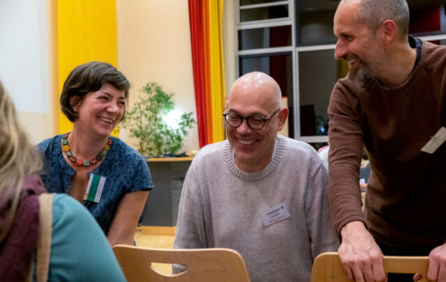 From Plessé to Marburg: (l-r) Merle Drusenbaum of Kollektiv von Morgen exchanges with Vincent Gaudin and Thierry Lohr, local councillors from Plessé, France, at the European Action-Gathering for Sustainable Food Systems in Marburg, Germany, 6-8 November 2023. Photo: Adèle Violette