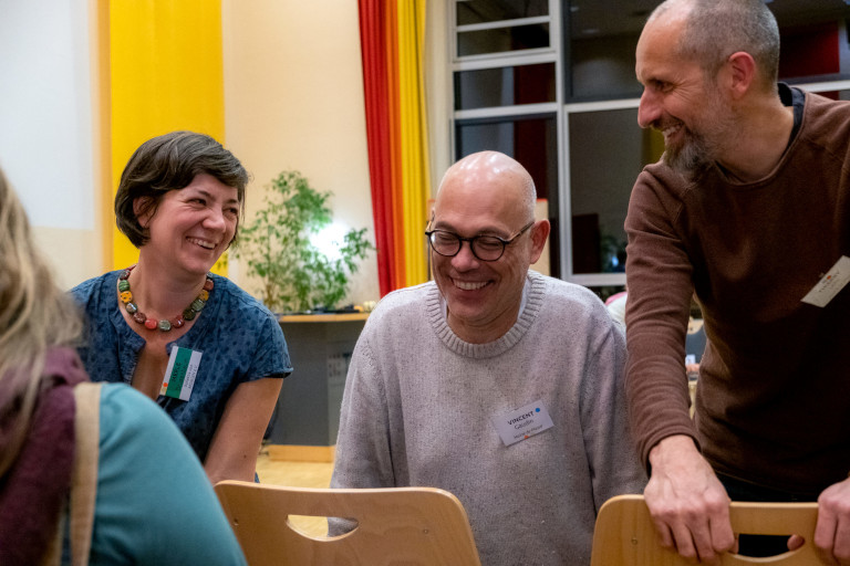 From Plessé to Marburg: (l-r) Merle Drusenbaum of Kollektiv von Morgen exchanges with Vincent Gaudin and Thierry Lohr, local councillors from Plessé, France, at the European Action-Gathering for Sustainable Food Systems in Marburg, Germany, 6-8 November 2023. Photo: Adèle Violette